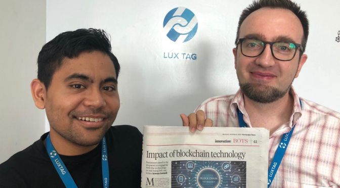 Faeez and Rene from LuxTag holding New Straits Times "innovation" section
