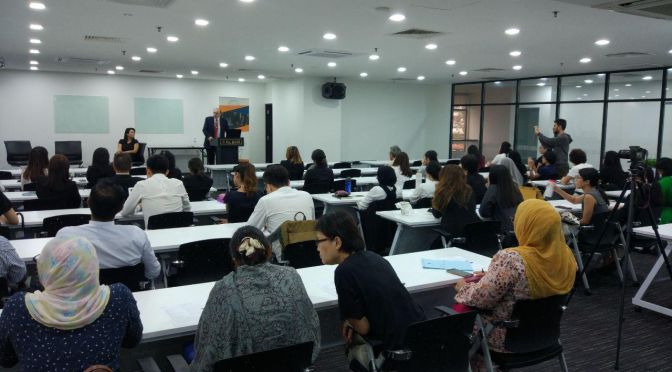 A person giving speech in a KL Bar seminar room